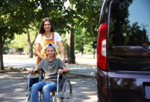 Adaptive Vans Brother and Sister Next to Handicap Van